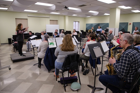a conductor conducts an adult band